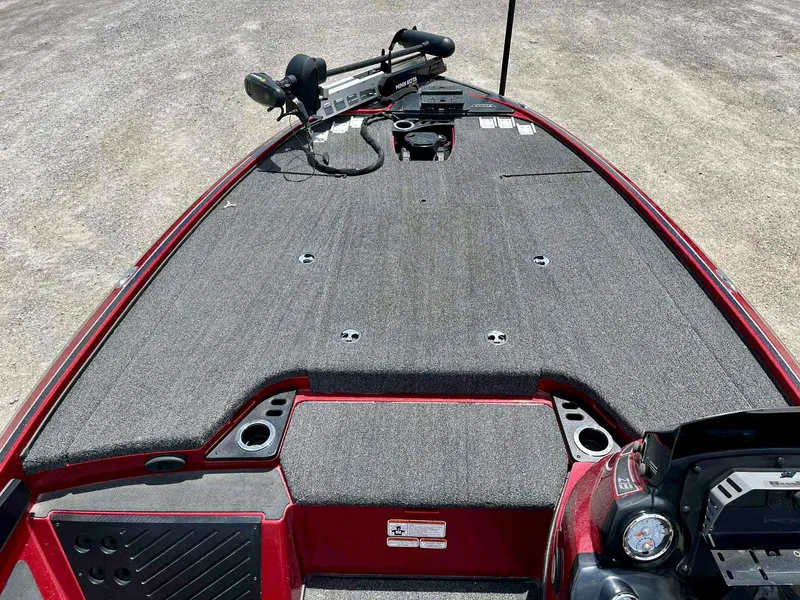 Slide: The Image of 2018 Nitro Z19 boat deck with gray carpeting and fishing equipment. - 7