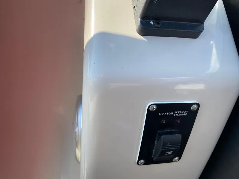 Slide: The Image of Control panel on 2016 Manitou 25 Aurora boat, featuring bilge pump switch. - 16