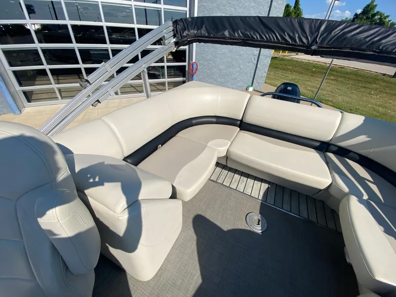 Slide: The Image of 2016 Manitou 25 Aurora boat interior with beige seating and canopy. - 17