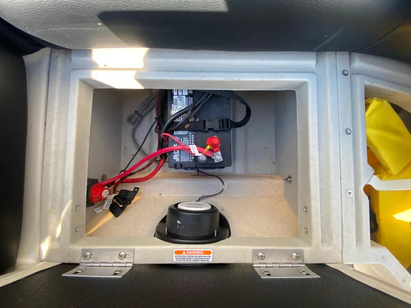 Slide: The Image of Battery compartment of 2016 Manitou 25 Aurora boat with wiring and safety warning. - 21