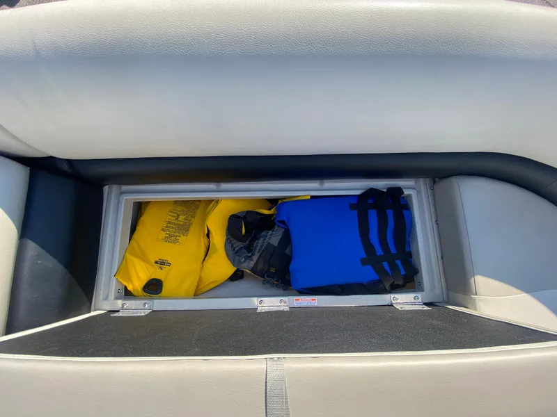 Slide: The Image of Storage compartment in 2016 Manitou 25 Aurora boat with life jackets. - 27