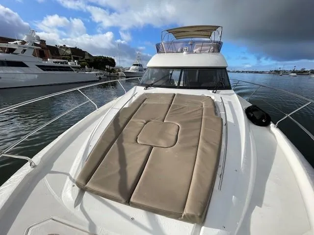 Slide: The Image of 2015 Prestige 500 Fly yacht with sunpad on deck, docked in marina. - 21