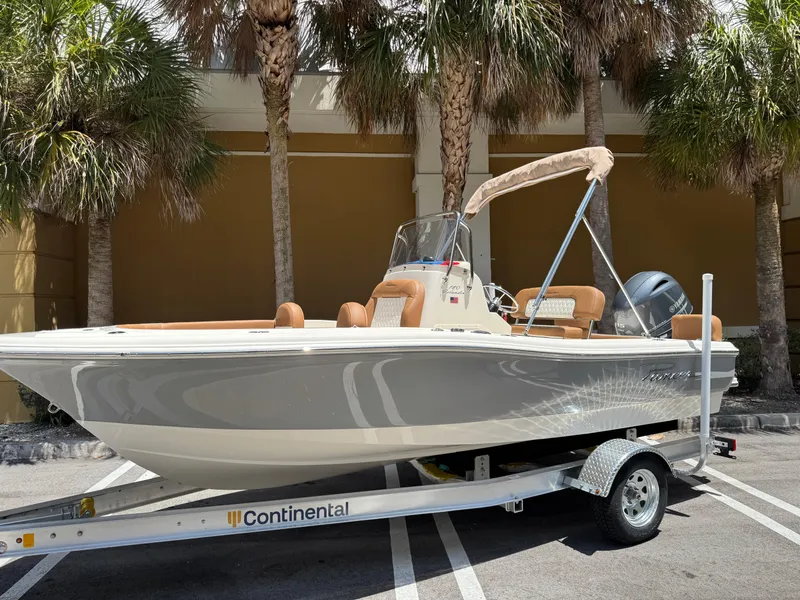 The Image of 2026 Pioneer 180 Islander boat on trailer, parked under palm trees. - 0