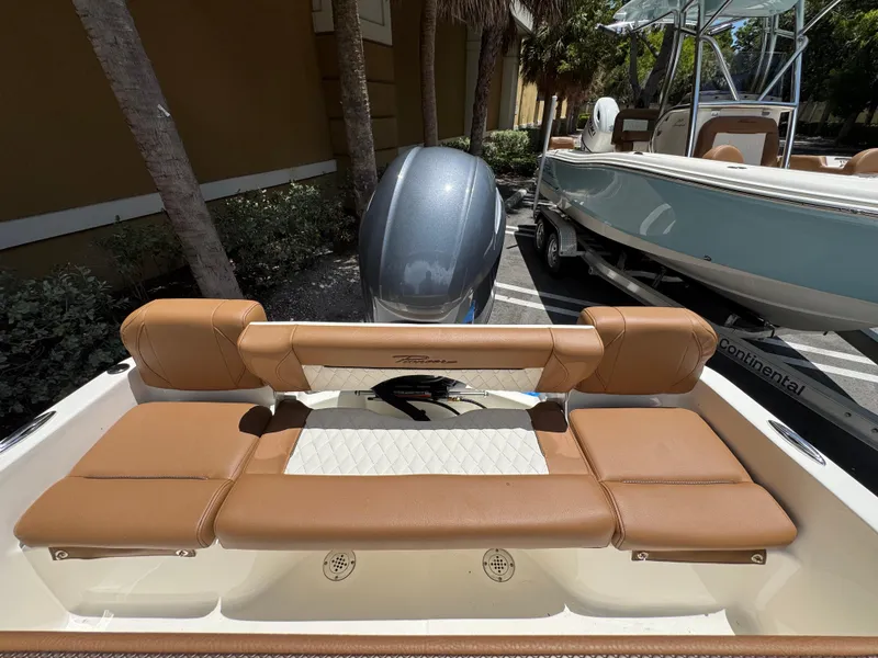 Slide: The Image of 2026 Pioneer 180 Islander boat with tan seating and outboard motor in a sunny setting. - 6