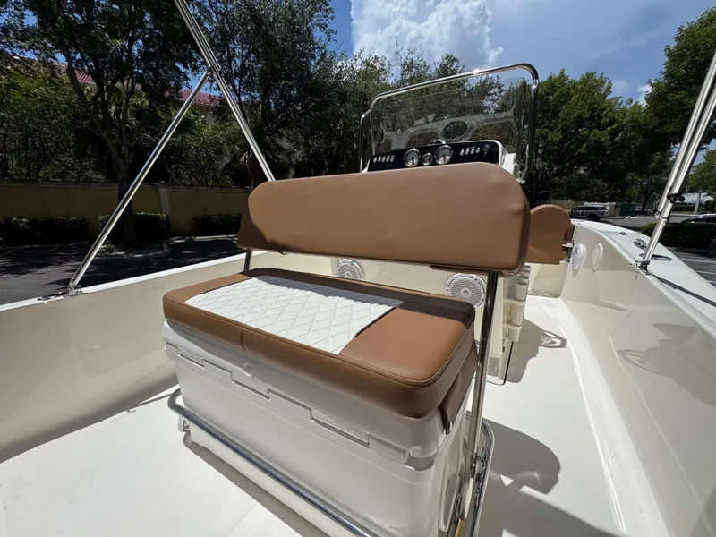 Slide: The Image of 2026 Pioneer 180 Islander boat interior with cushioned seating and steering console. - 8
