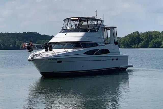 Slide: The Image of 2005 Carver 444 Cockpit Motor Yacht on calm lake waters. - 1