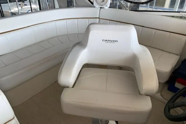 Slide: The Image of 2005 Carver 444 Cockpit Motor Yacht interior with white seating and helm chair. - 11