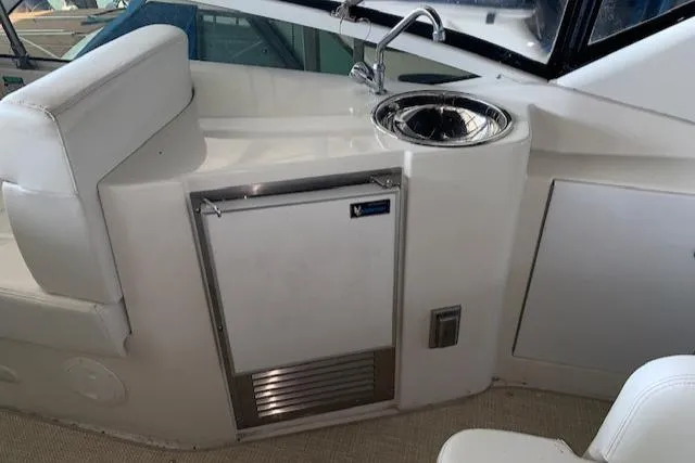 Slide: The Image of 2005 Carver 444 Cockpit Motor Yacht interior with sink and seating area. - 12