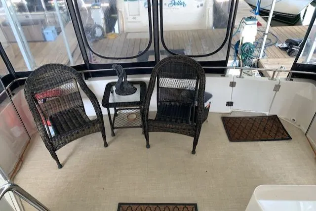 Slide: The Image of 2005 Carver 444 Cockpit Motor Yacht interior with wicker chairs and table. - 14