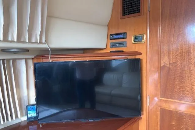 Slide: The Image of Interior of 2005 Carver 444 Cockpit Motor Yacht with TV and wooden cabinetry. - 17