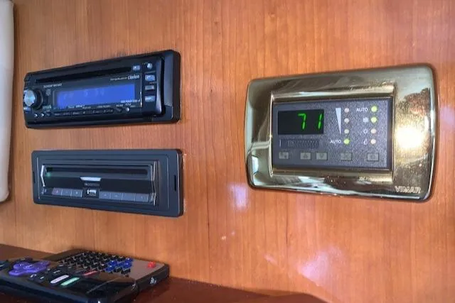 Slide: The Image of Control panel of a 2005 Carver 444 Cockpit Motor Yacht with stereo and thermostat. - 19
