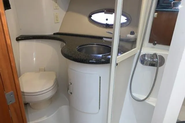 Slide: The Image of 2005 Carver 444 Cockpit Motor Yacht bathroom with sink, toilet, and shower. - 24