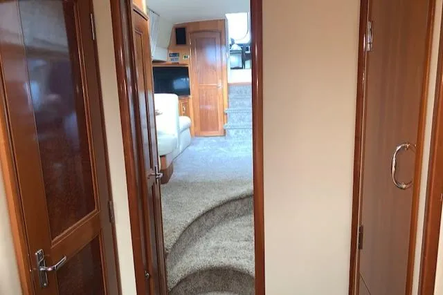Slide: The Image of Interior view of 2005 Carver 444 Cockpit Motor Yacht with carpeted stairs and wooden cabinetry. - 25
