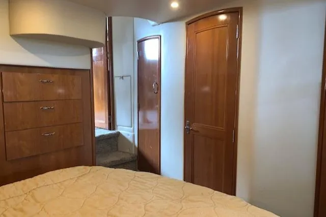 Slide: The Image of Interior of 2005 Carver 444 Cockpit Motor Yacht with wooden cabinetry and cozy bedroom. - 26