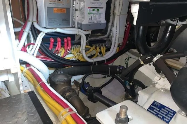Slide: The Image of Engine room of 2005 Carver 444 Cockpit Motor Yacht with wiring and mechanical components. - 33