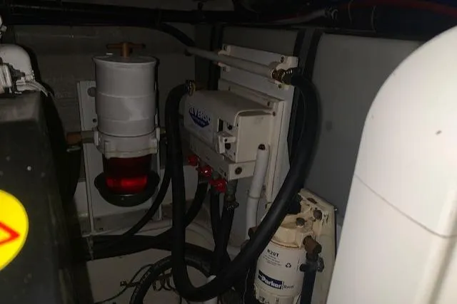 Slide: The Image of Engine room of 2005 Carver 444 Cockpit Motor Yacht with fuel and filtration systems. - 34