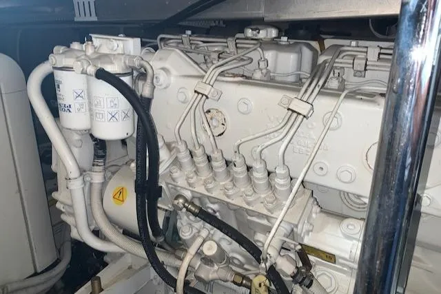 Slide: The Image of Engine compartment of a 2005 Carver 444 Cockpit Motor Yacht, showcasing detailed mechanical components. - 35