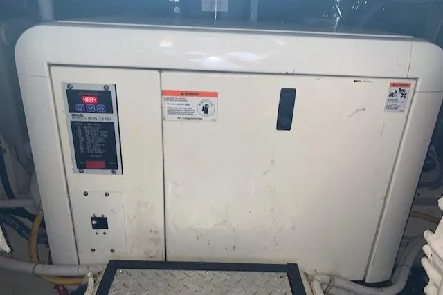 Slide: The Image of 2005 Carver 444 Cockpit Motor Yacht engine compartment with control panel and safety warnings. - 36