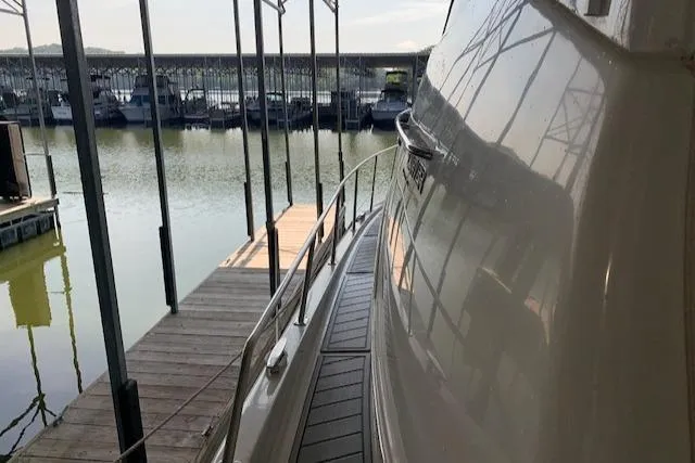 Slide: The Image of 2005 Carver 444 Cockpit Motor Yacht docked at marina, side view. - 7