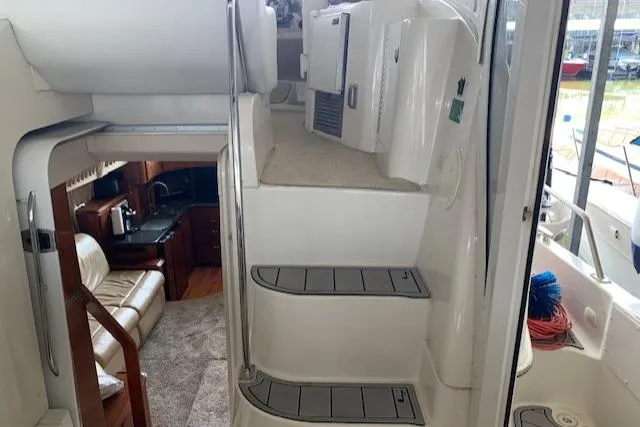 Slide: The Image of 2005 Carver 444 Cockpit Motor Yacht interior with stairs and cozy seating area. - 8