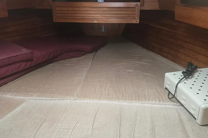 Slide: The Image of Cozy cabin interior of 1987 Saturna 33 sailboat with cushions and storage. - 12