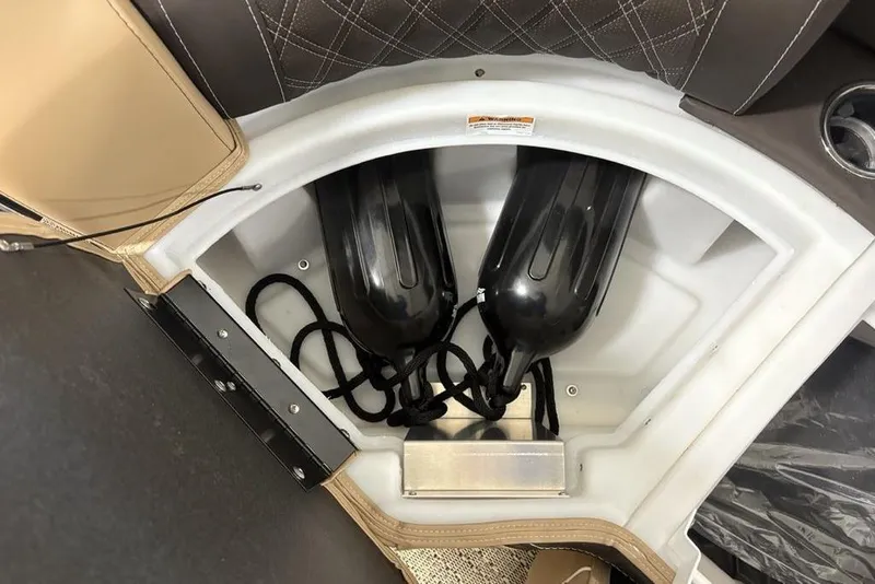 Slide: The Image of 2025 Barletta L25U boat interior with beige flooring and storage hatch. - 14