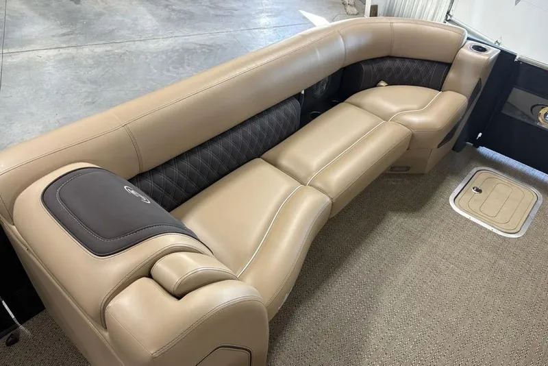 Slide: The Image of Storage compartment in 2025 Barletta L25U boat with beige interior and black cover. - 15