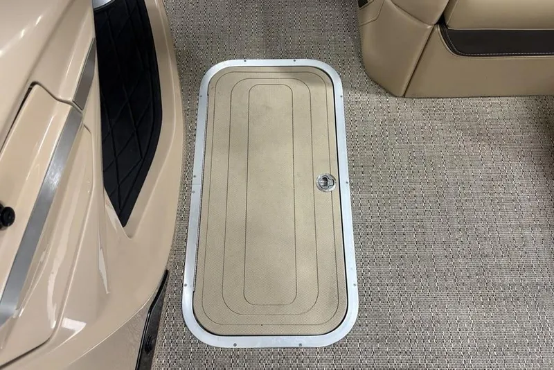 Slide: The Image of 2025 Barletta L25U boat storage compartment with cup holder and cushioned seating. - 16