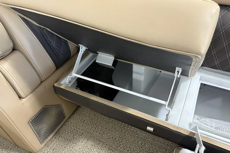 Slide: The Image of Storage compartment in 2025 Barletta L25U boat with wrapped item and folded flag. - 19