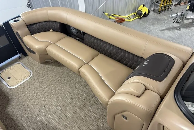 Slide: The Image of 2025 Barletta L25U boat interior with beige seating and cup holders. - 2