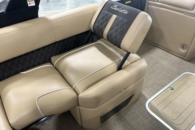 Slide: The Image of Interior view of 2025 Barletta L25U boat dashboard with steering wheel and controls. - 24