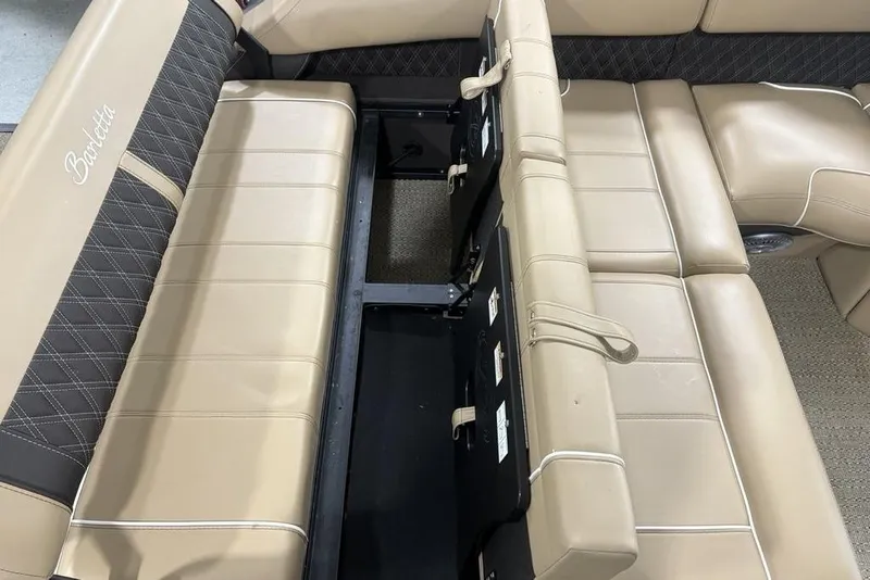 Slide: The Image of 2025 Barletta L25U pontoon boat interior with beige seating and modern dashboard. - 37