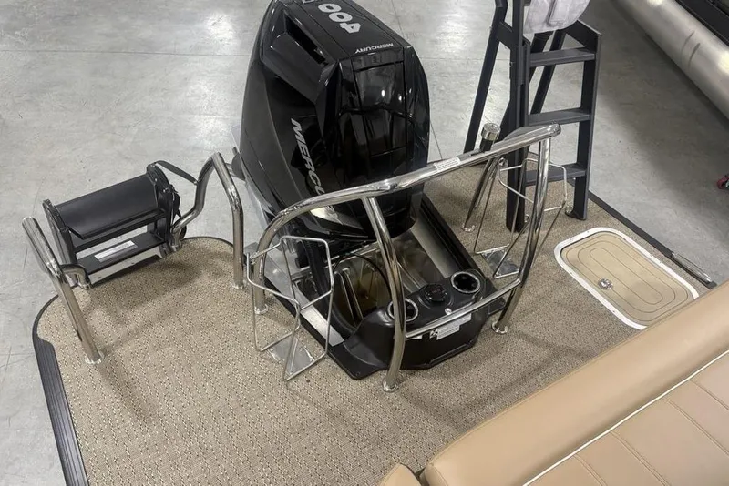 Slide: The Image of 2025 Barletta L25U pontoon boat interior with tan seating in showroom. - 38