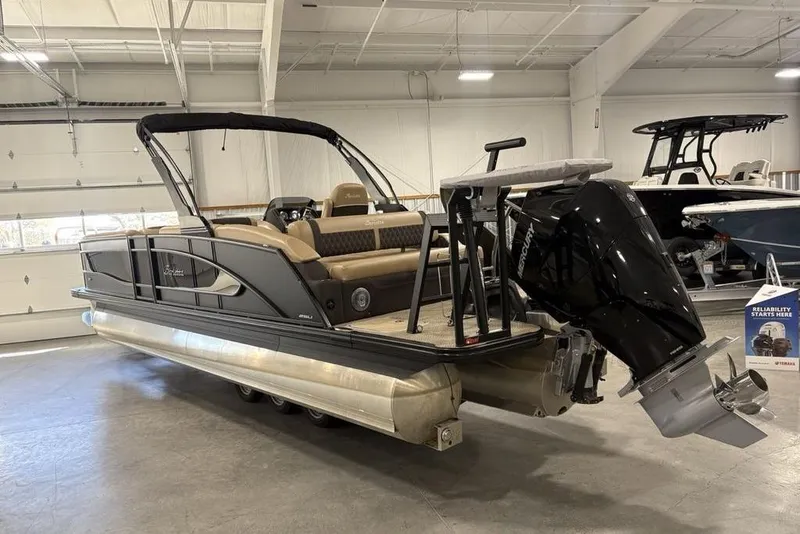 Slide: The Image of 2025 Barletta L25U interior with beige upholstery and storage compartment. - 8