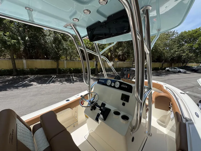 Slide: The Image of 2026 Pioneer 202 Sportfish boat interior with steering console and seating. - 12