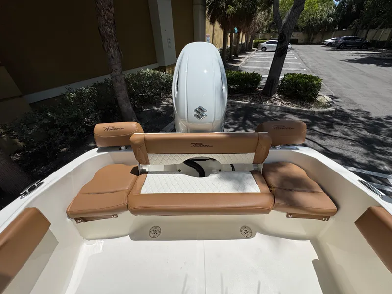 Slide: The Image of 2026 Pioneer 202 Sportfish boat with tan seating and Suzuki outboard motor. - 5