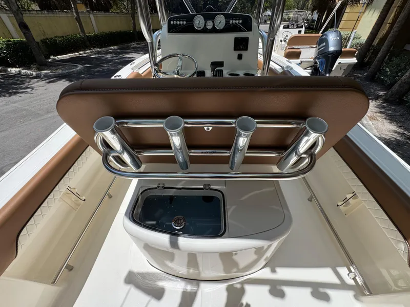 Slide: The Image of 2026 Pioneer 202 Sportfish boat interior with rod holders and seating. - 6