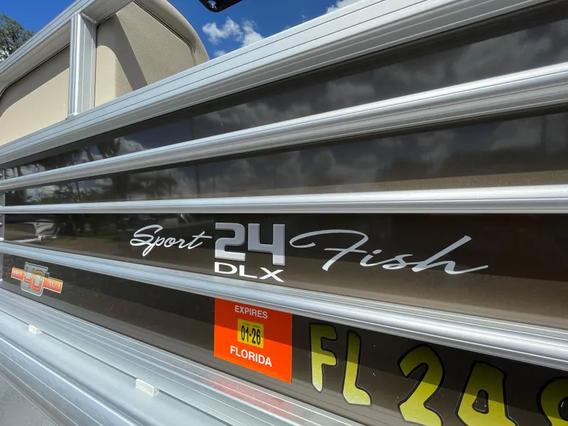 Slide: The Image of 2023 Bass Tracker Sportfish 24 DLX boat with Florida registration sticker. - 12