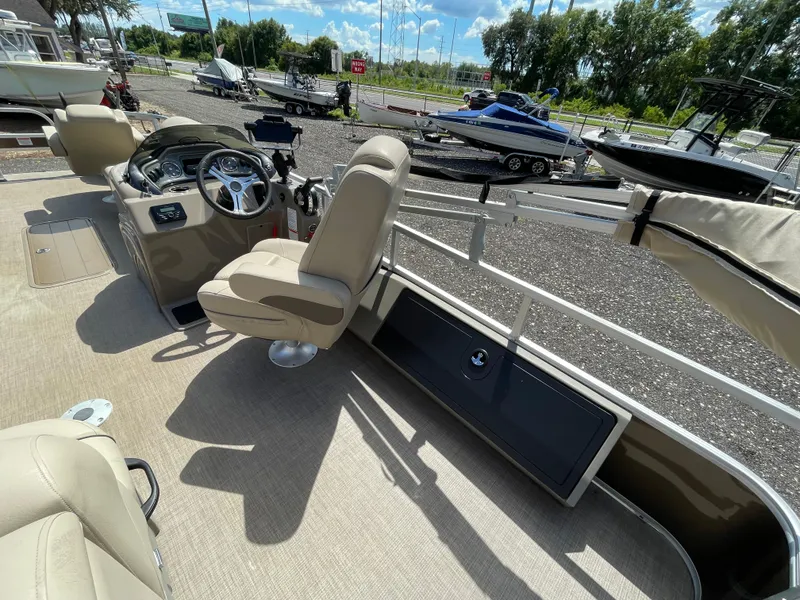 Slide: The Image of 2023 Bass Tracker Sportfish 24 DLX interior with steering console and seating. - 7