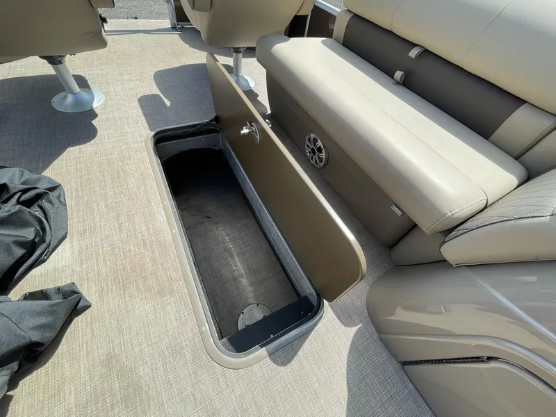 Slide: The Image of 2023 Bass Tracker Sportfish 24 DLX boat with open storage compartment under seat. - 9