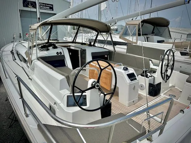 Slide: The Image of 2023 Jeanneau Sun Odyssey 440 sailboat with dual helm, docked at marina. - 0