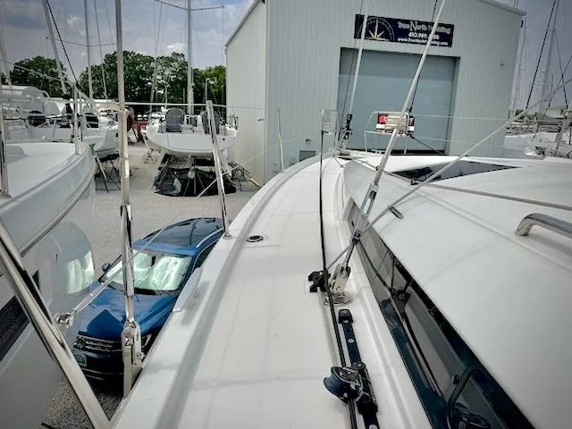 Slide: The Image of 2023 Jeanneau Sun Odyssey 440 sailboat docked near a marina building. - 10
