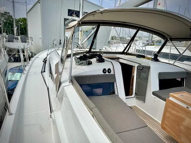 Slide: The Image of 2023 Jeanneau Sun Odyssey 440 sailboat cockpit with canopy and seating area. - 12