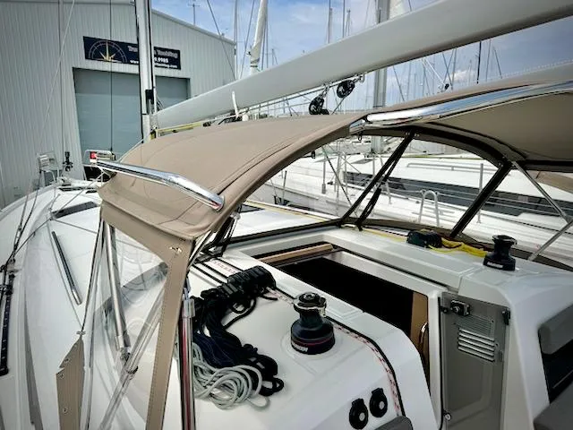 Slide: The Image of 2023 Jeanneau Sun Odyssey 440 sailboat cockpit with ropes and winch, docked at marina. - 13