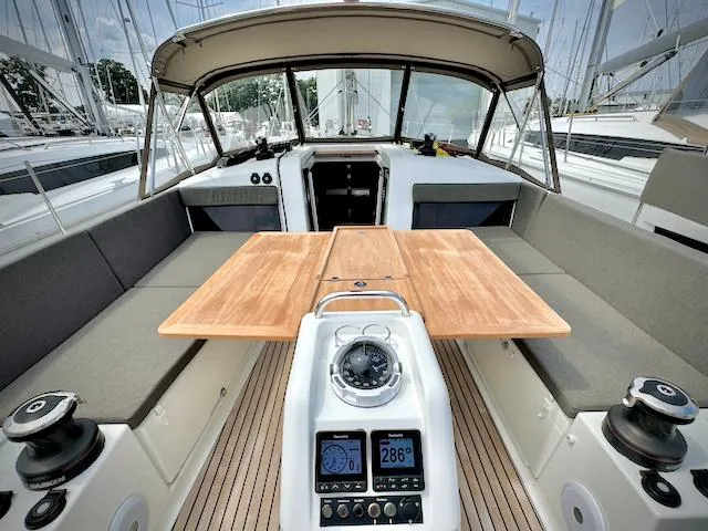 Slide: The Image of 2023 Jeanneau Sun Odyssey 440 yacht cockpit with wooden table and navigation instruments. - 15