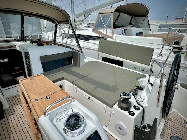 Slide: The Image of 2023 Jeanneau Sun Odyssey 440 yacht cockpit with modern seating and navigation equipment. - 16