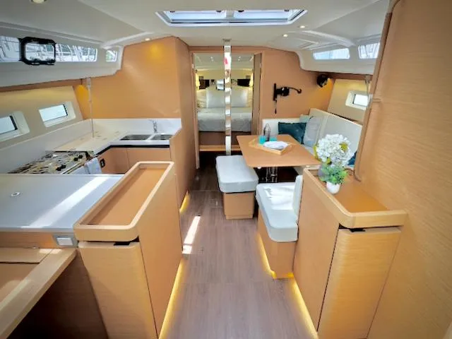 Slide: The Image of Interior of 2023 Jeanneau Sun Odyssey 440 yacht, featuring modern kitchen and cozy seating area. - 25