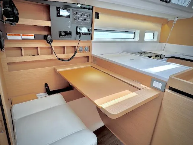 Slide: The Image of Interior of 2023 Jeanneau Sun Odyssey 440 yacht, featuring a modern navigation station. - 28