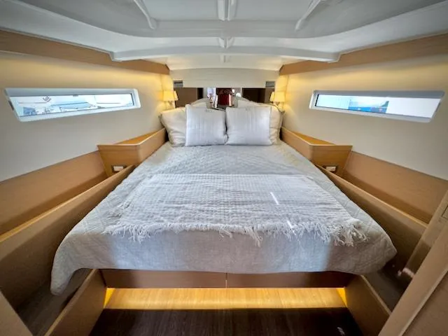 Slide: The Image of Luxurious cabin interior of 2023 Jeanneau Sun Odyssey 440 yacht with cozy bedding. - 3