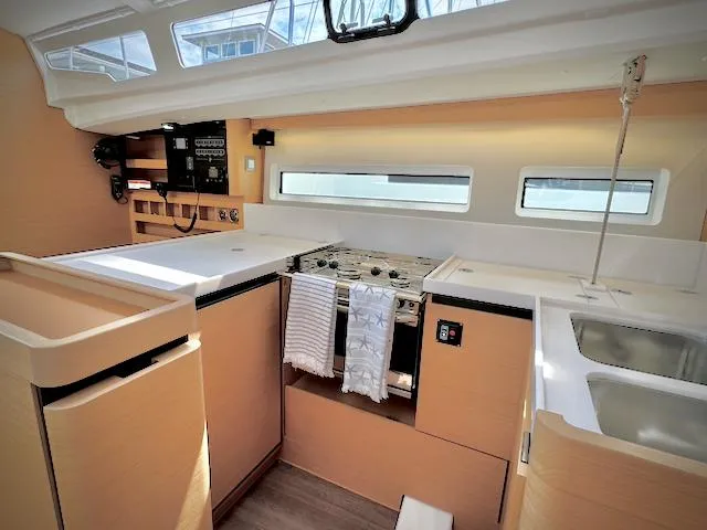 Slide: The Image of Interior of 2023 Jeanneau Sun Odyssey 440 yacht, featuring modern kitchen and sleek design. - 31